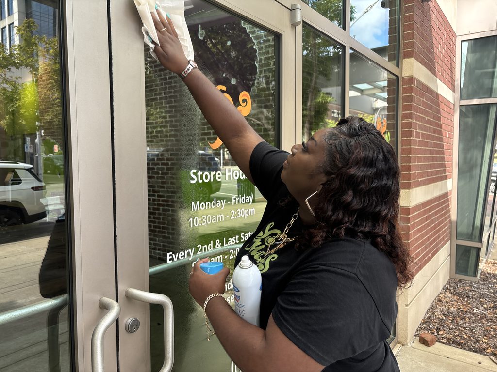 Jamyia cleaning windows at Yo' Mama's